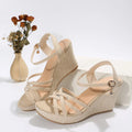 Women's black wedge sandals with a fish mouth open toe and cloth upper.