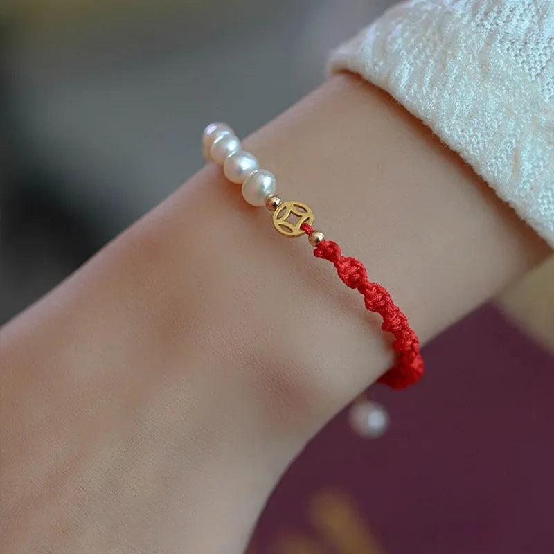 Women's pearl braided red rope bracelet with domestic 14K gold plated fu character charm on red background