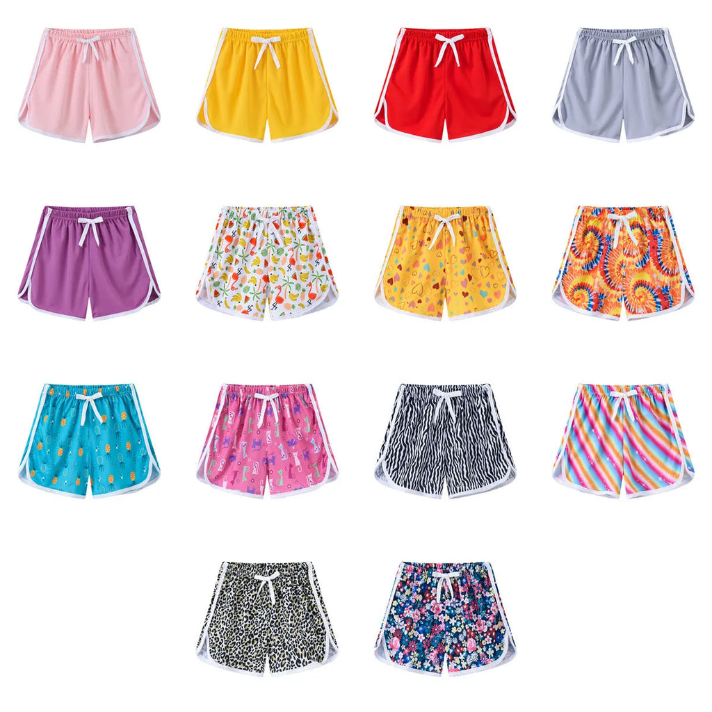 Children's polyester casual shorts in multiple colours and patterns including stripes, leopard print, and floral designs.