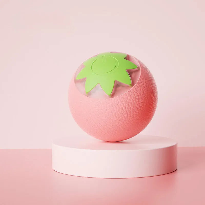 Electric rolling ball toy for dogs and cats in green, pink, and yellow on a light background