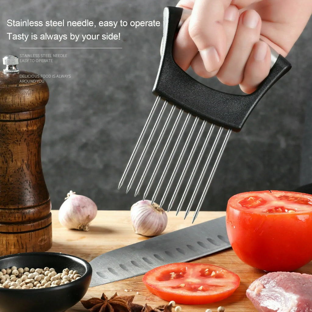 Stainless steel onion holder slicer with non-slip base on a kitchen counter next to a tomato and knife