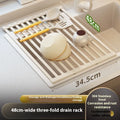 Milky white foldable stainless steel draining rack showing tri-fold design with dishes