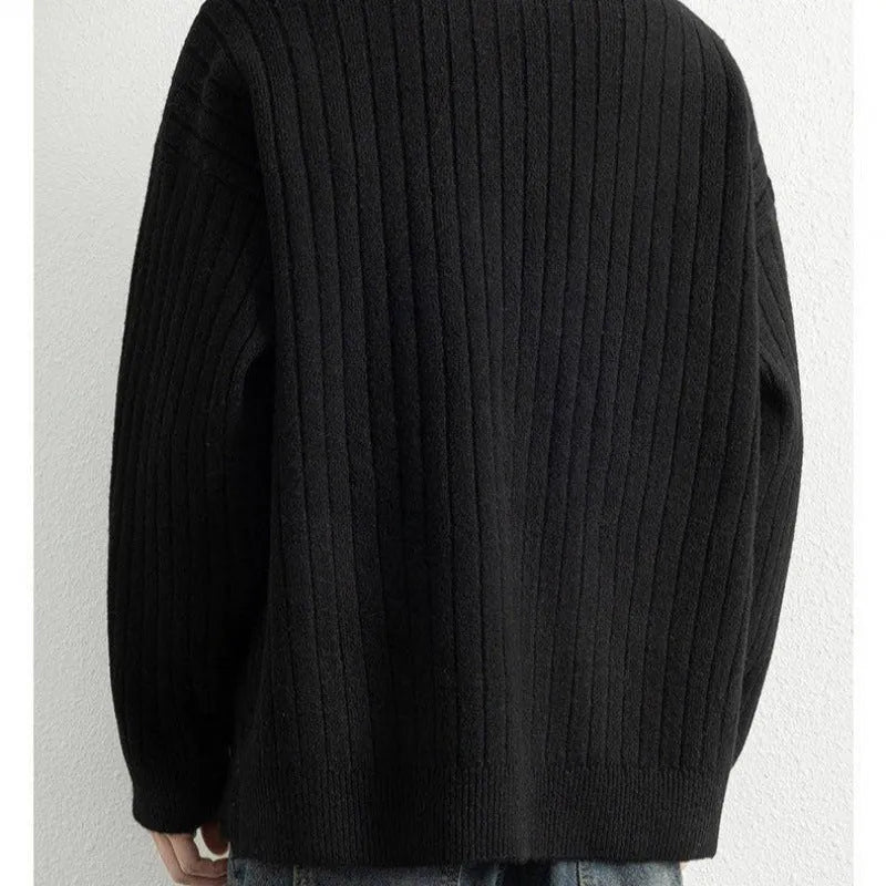 Men's loose grey half zip sweater with textured knit and long sleeves.