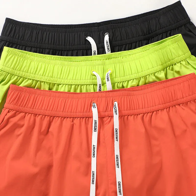 Men's loose beach surfing shorts in orange, green or black with elastic waistband