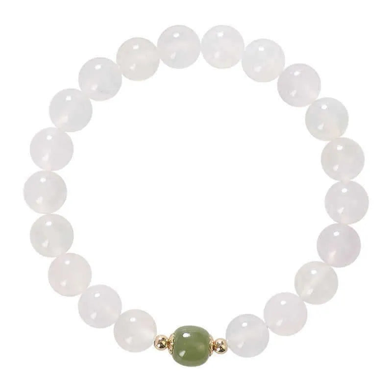 Handmade white agate crystal bracelet with cinnabar accents showing 6mm and 8mm bead sizes