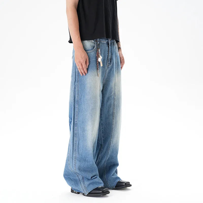 Cut washed vintage washed wide leg machete jeans in light blue denim with zipper fly, front view
