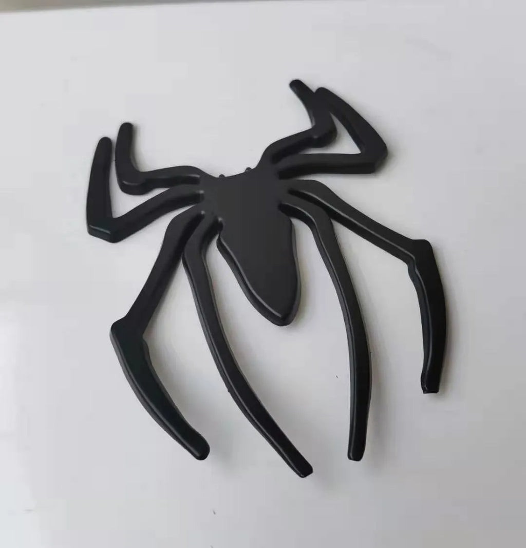 3D metal spider car bumper sticker in gold, silver, black, or red on a white background