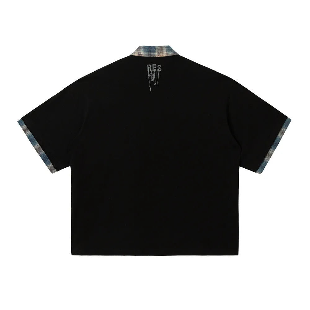 Men's loose blue short-sleeved top with asymmetric lapel and graffiti-style print.