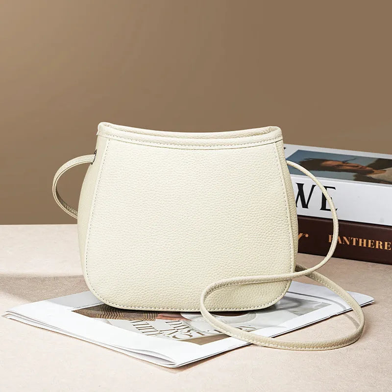 Women's genuine cowhide messenger bag in beige with soft surface leather, square vertical shape, and removable handle