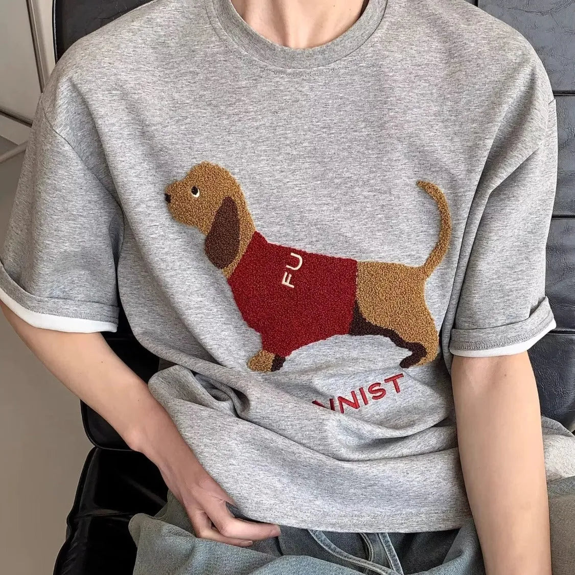 Grey men's cotton t-shirt with embroidered dachshund dog holding a towel graphic.