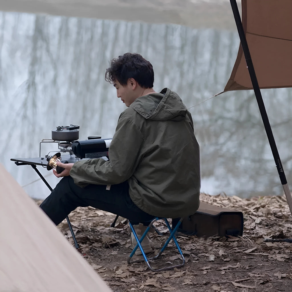 Black aluminium alloy folding camping stool shown in folded and unfolded positions