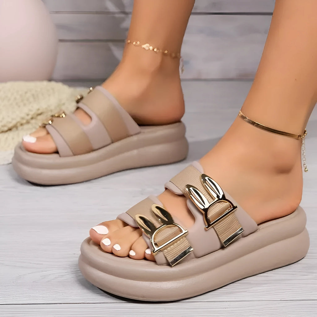 Women's apricot suede slippers with a thick light-coloured rubber sole, shown from the side.