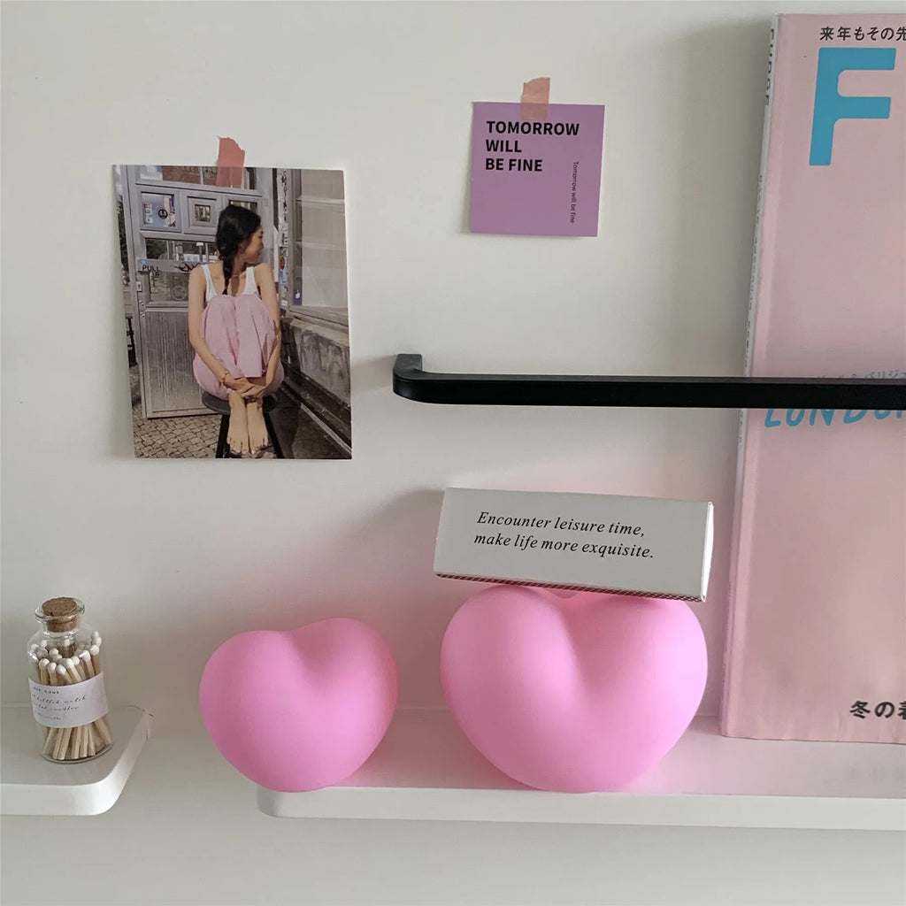 White or pink vinyl atmosphere lamp emitting warm light, shown in small and large size options.