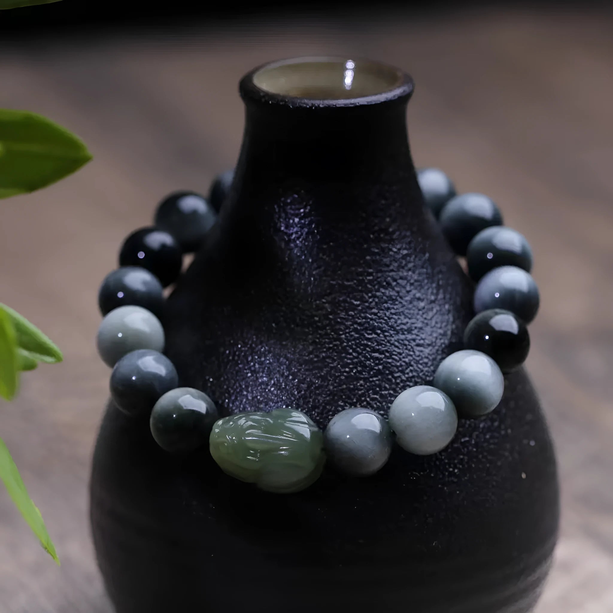 10mm black eagle eye stone and natural Hetian jade clear water Pixiu bracelet on a neutral background
