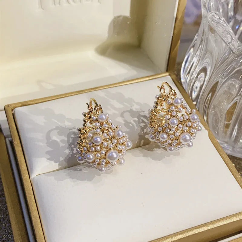 Gold copper drop earrings with small rice-shaped pearl inlay in a flower basket shape for women