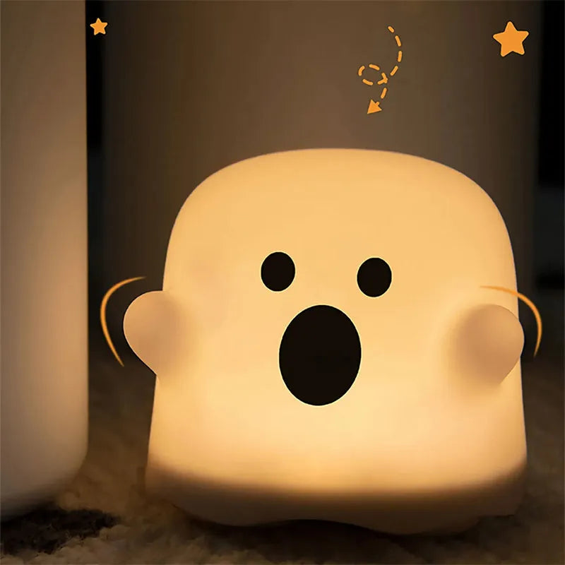 Silicone night light in Ah Ah style on a bedside table with soft glow