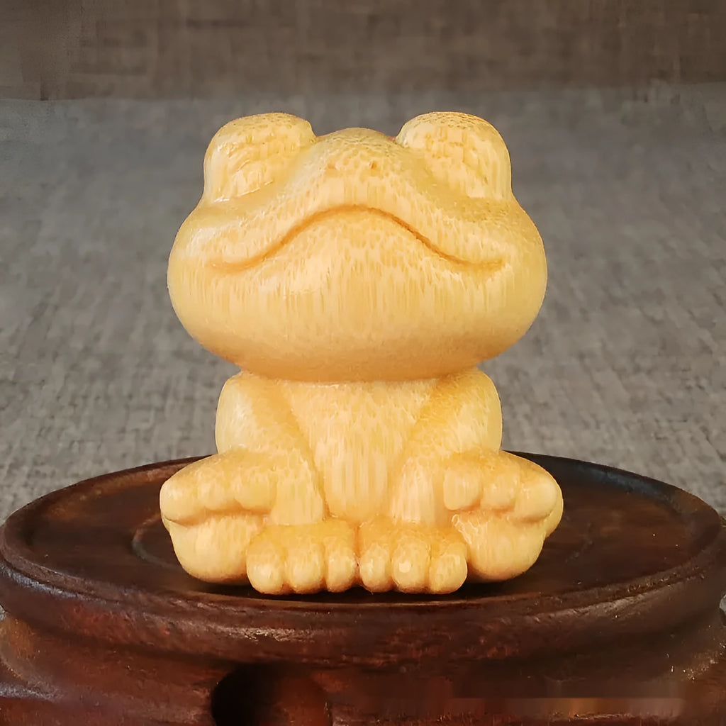 Solid bamboo carved ornament of a smiling cartoon frog, 5cm tall.