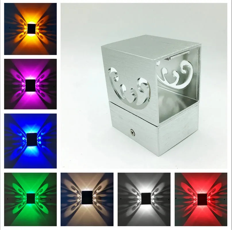Modern silver aluminium butterfly-shaped LED wall lamp with multi-colour light options.