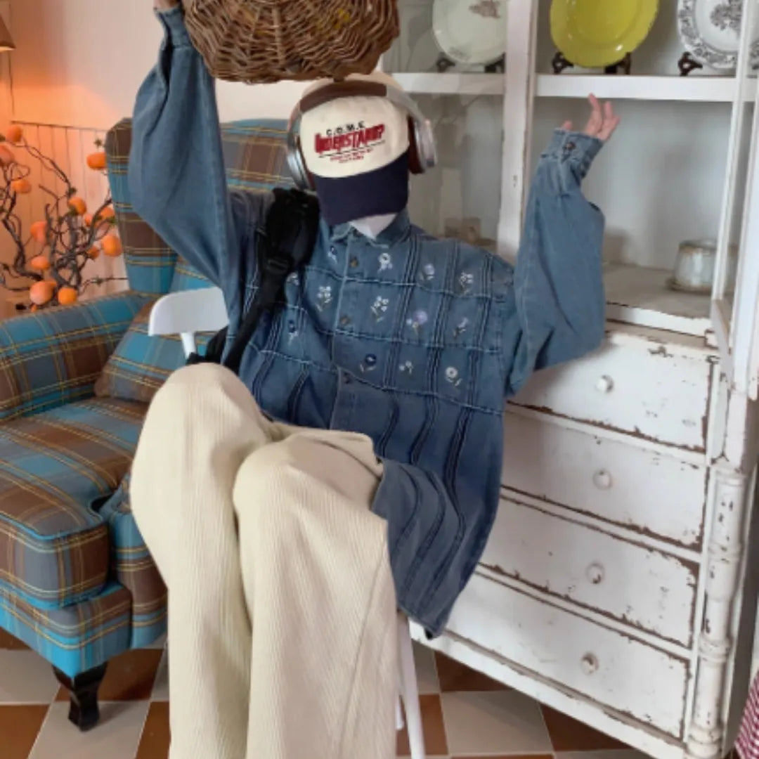 Washed blue long sleeved denim shirt with small floral pattern and pleated details on front