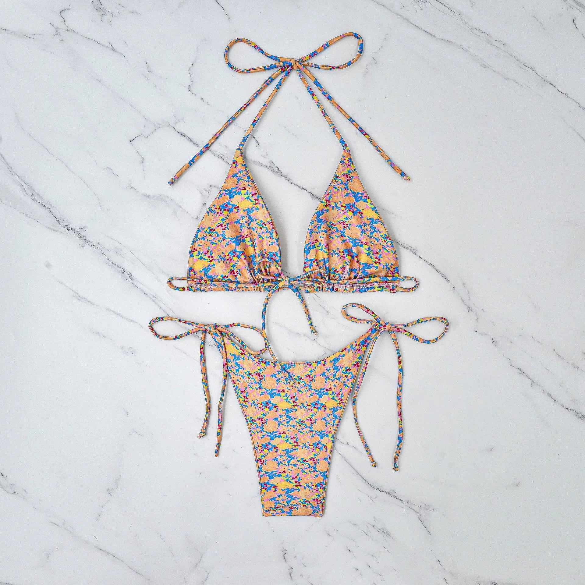 A pictured colour lace-up bikini swimsuit with adjustable ties and a backless briefs design.