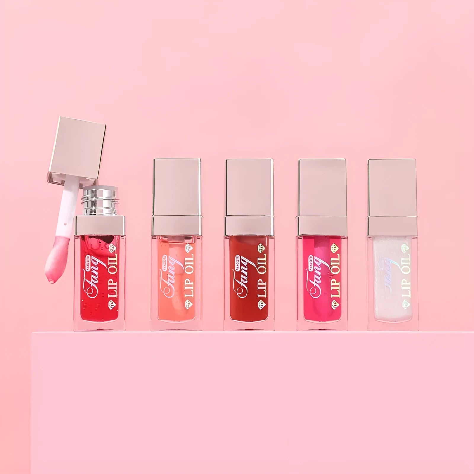 Five tubes of bright mint lip gloss lipstick in different shades on a white background.