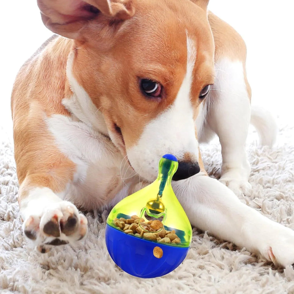 Blue tumbler-shaped interactive treat dispenser ball for dogs and cats on a wooden floor