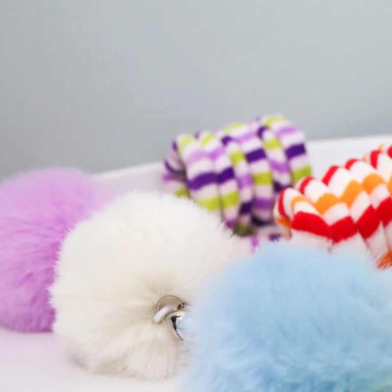 Kitten toy with hanging bell stick and inflatable ball attached by suction cup, available in blue, green, purple, red, or yellow