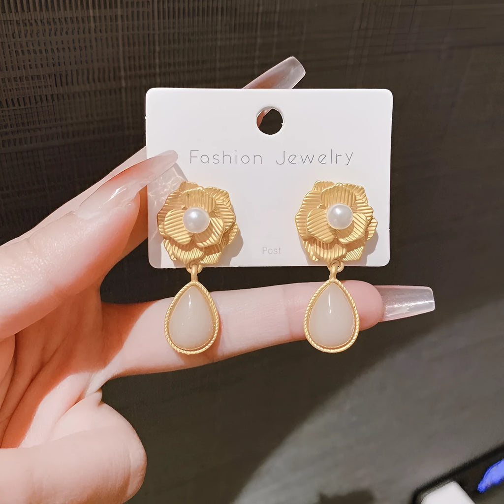 Gold electroplated alloy stud earrings with needle rose pearl design, ice flower motif, and opal stone accent