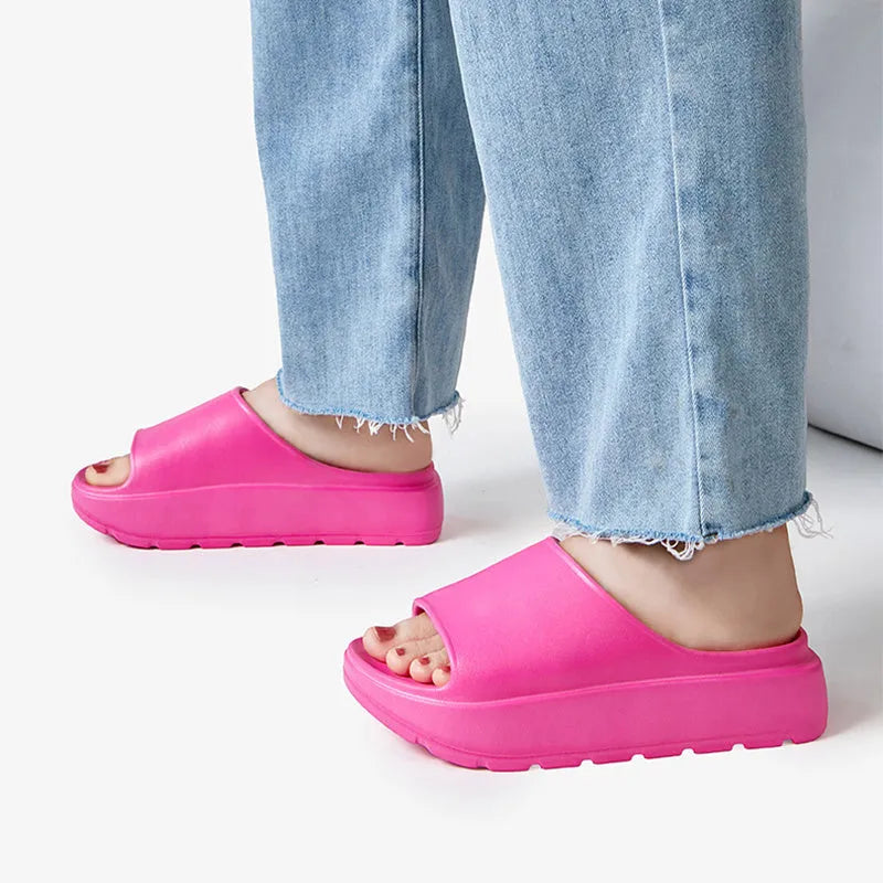 Women's beige fish mouth slippers with a thick 5.5cm light-coloured EVA sole on a wooden floor.