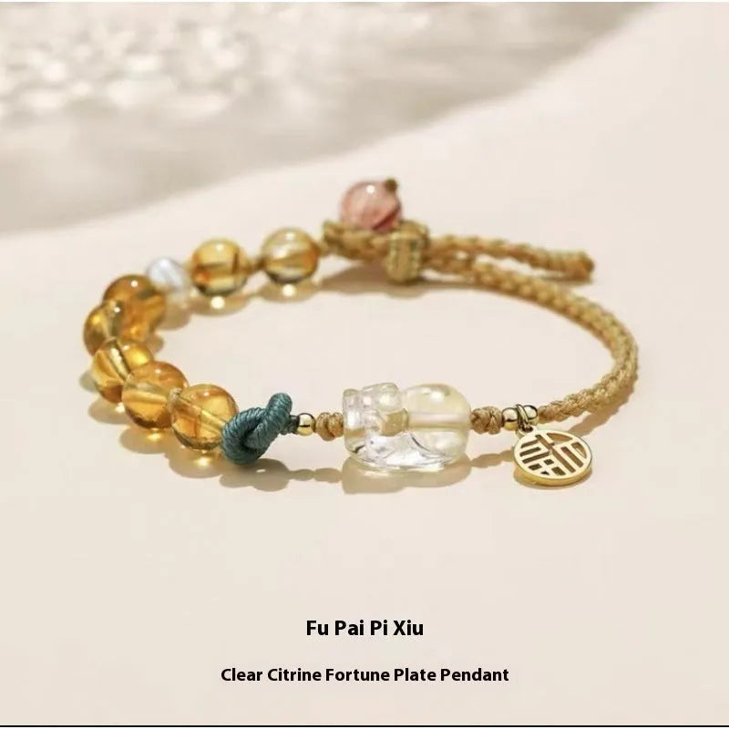Hand-woven citrine crystal bracelet with zodiac design on neutral background