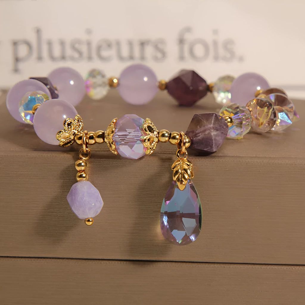 Children's crystal bracelet with lavender purple water-drop crystals on a plain background
