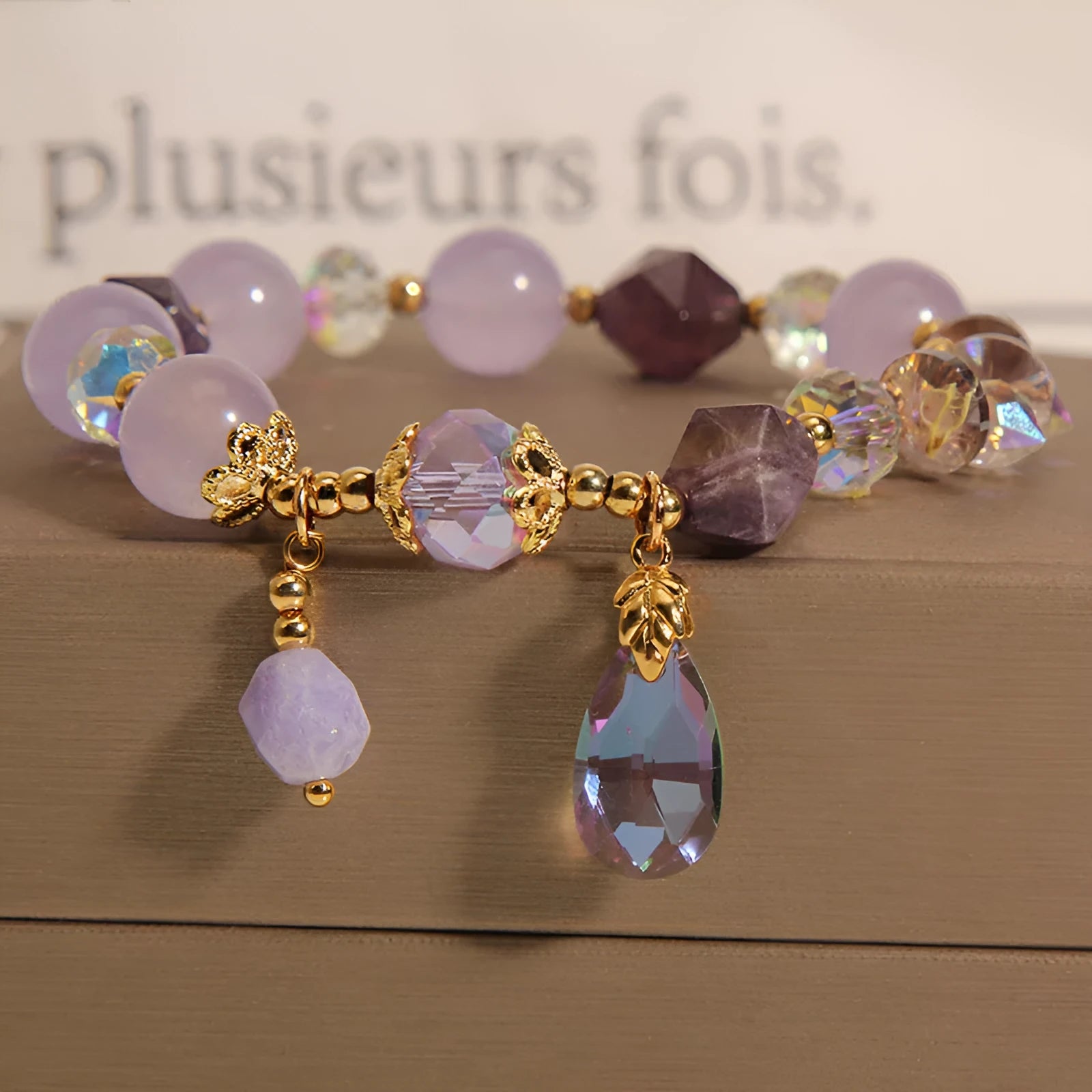 Children's crystal bracelet with lavender purple water-drop crystals on a plain background