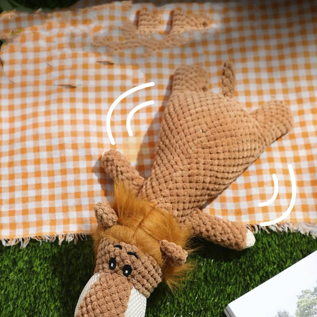 Green, grey, and yellow plush dog chew toy with textured surface and animal shape.