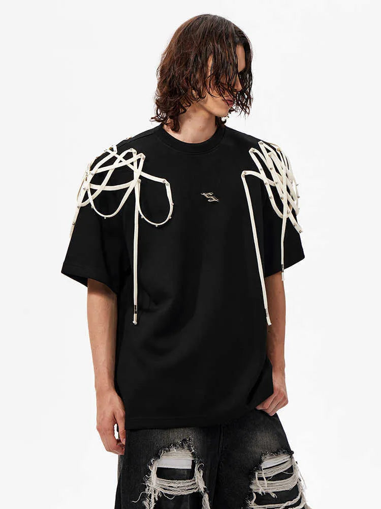 Black loose fit short-sleeve T-shirt with padded shoulders and decorative rivet ribbons.