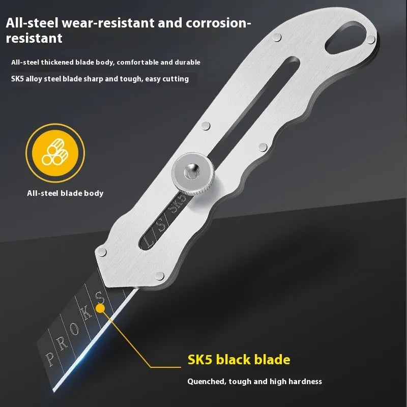 Stainless steel folding art knife with black blade, showing open position on work surface