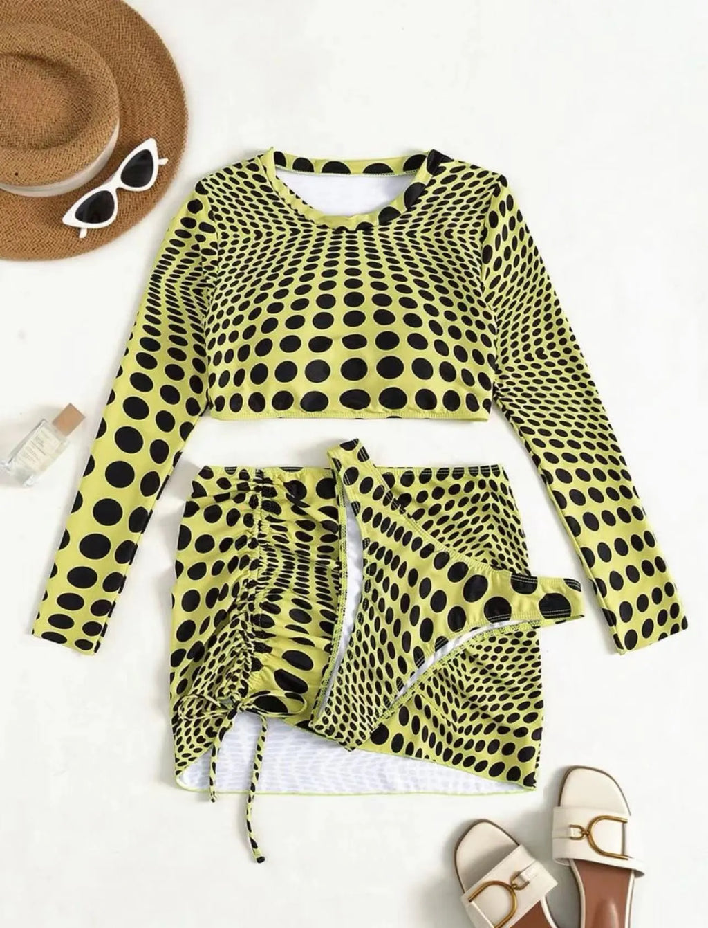 Women's green polka dot three-piece swimsuit set with top, skirt, and bra