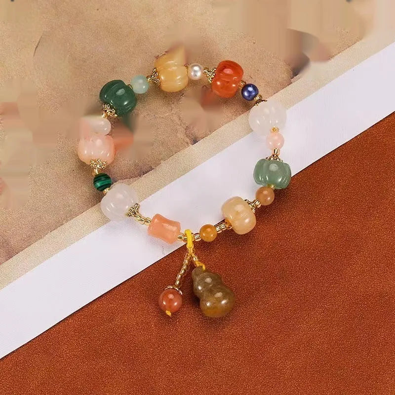 Bodhi root bracelet with carved lotus, pumpkin, and white jade beads in multiple sizes