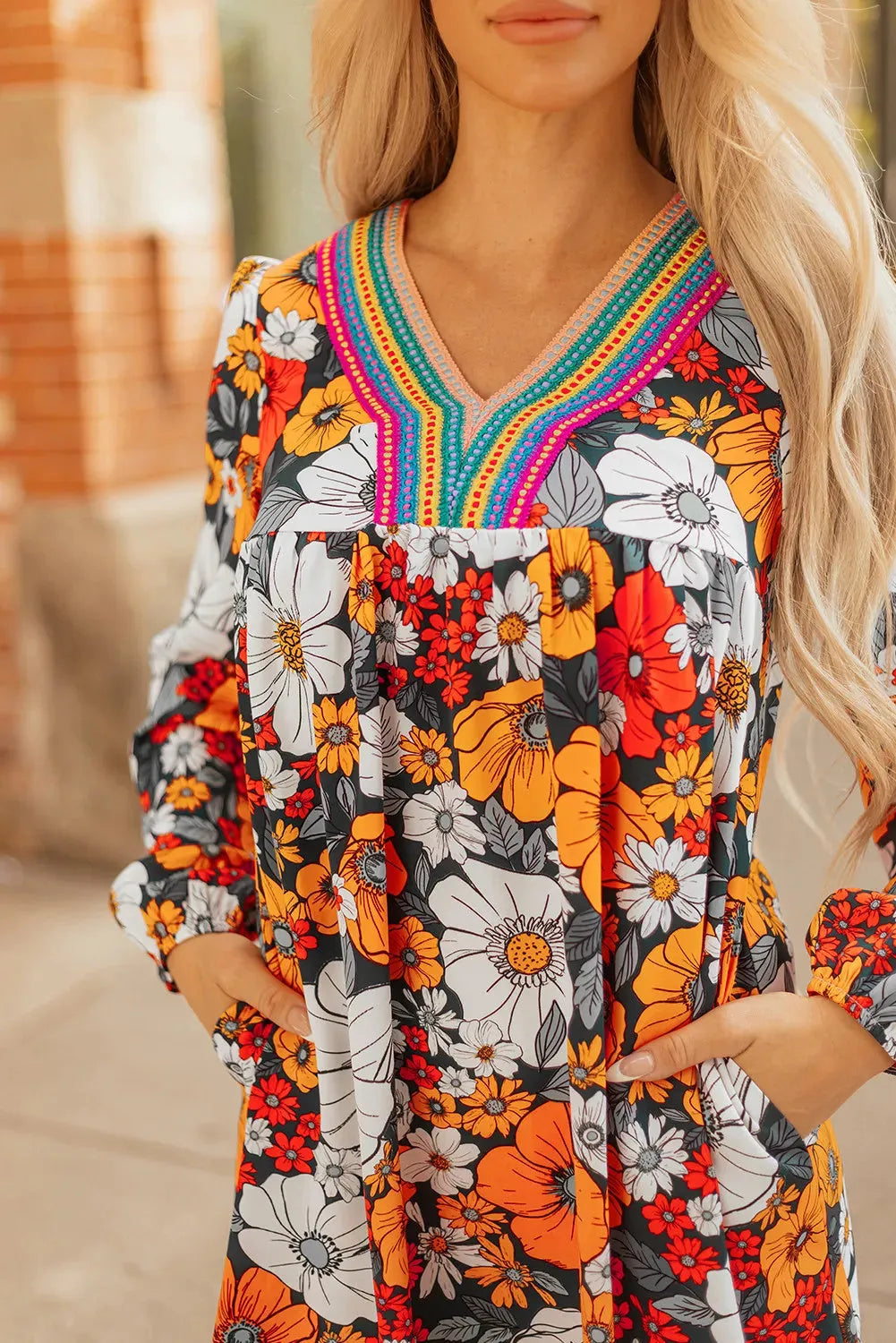Orange floral print striped lace V-neck long sleeve mini dress on mannequin