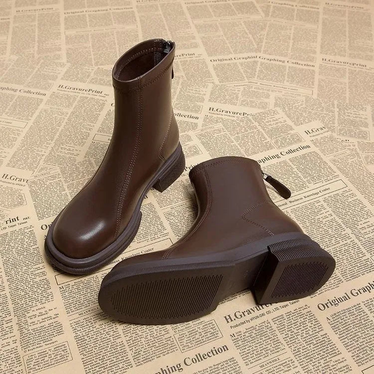 Women's black ankle boots with flat heel and rear zipper, round toe design