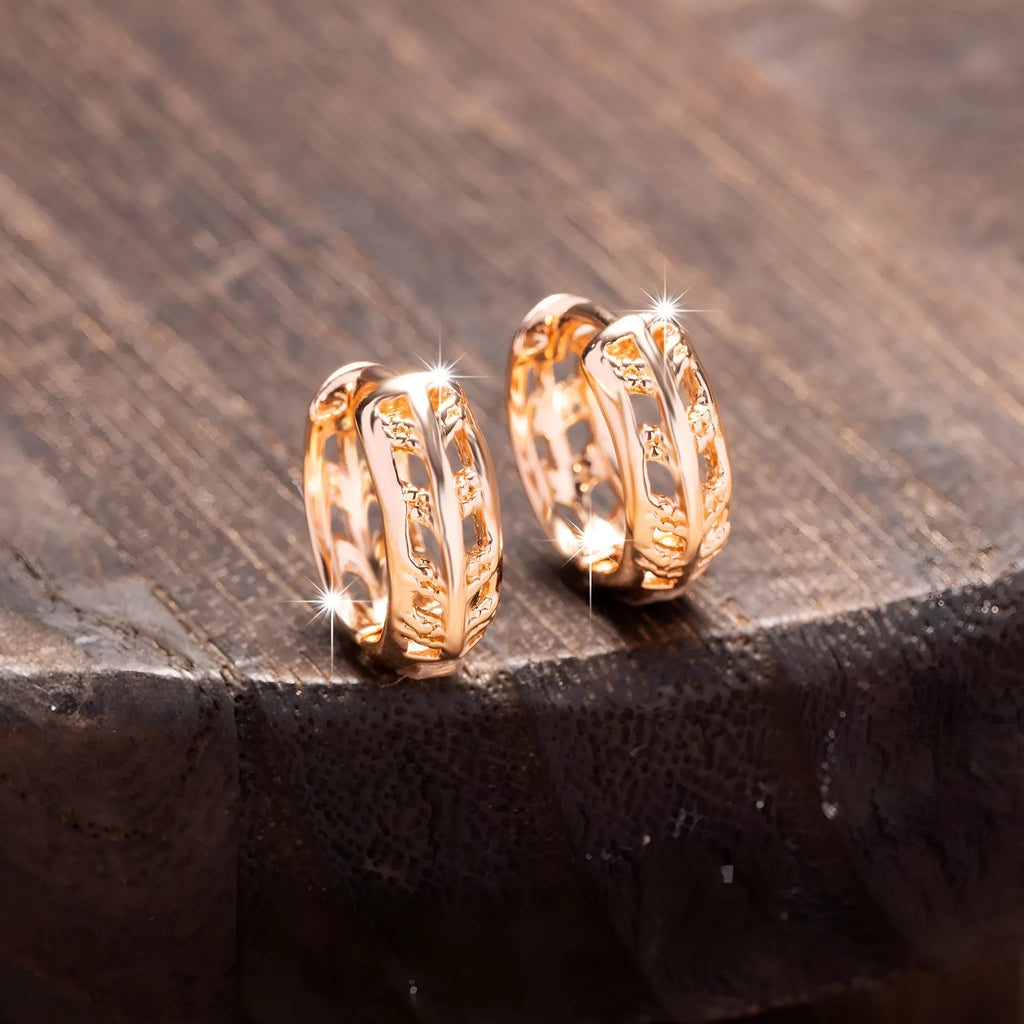 Rose gold plated copper earrings with hollowed-out leaf and heart shapes creating intricate cut-out patterns
