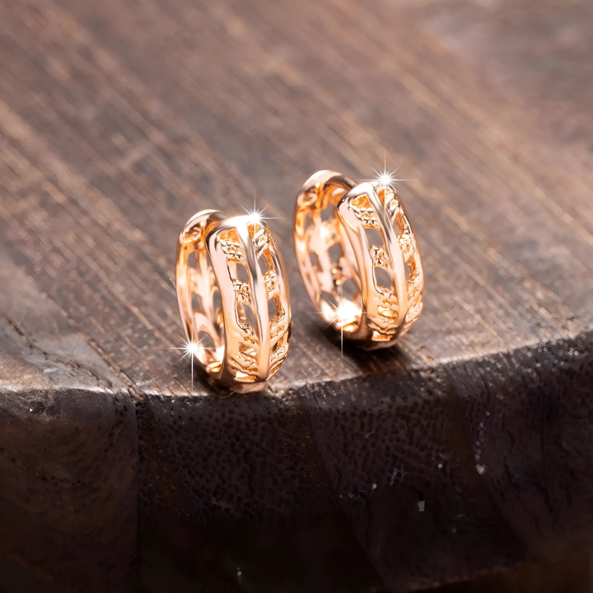 Rose gold plated copper earrings with hollowed-out leaf and heart shapes creating intricate cut-out patterns