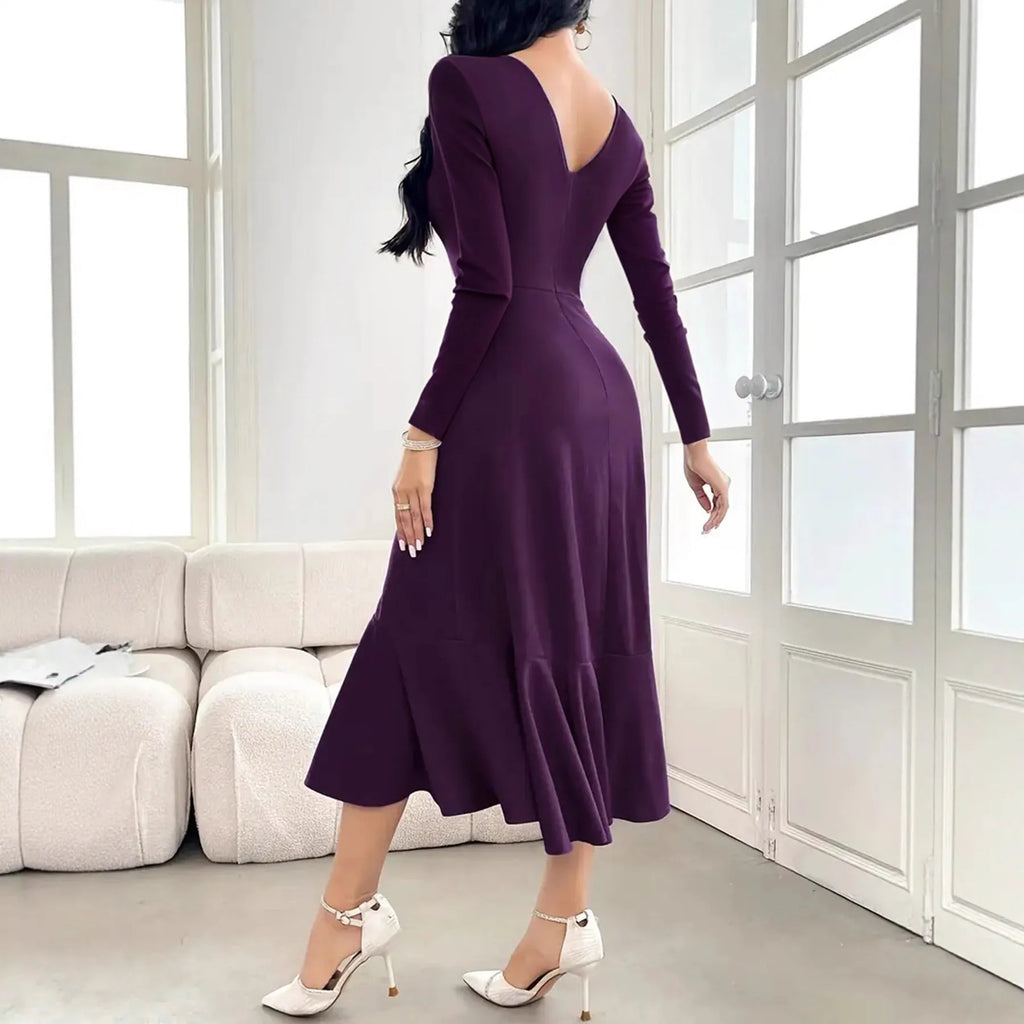 Purple women's dress with ruffled detailing, long sleeves and round neckline on mannequin