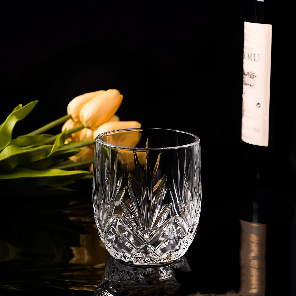Clear thick-bottomed whiskey glass with 301-400ml capacity on a table.