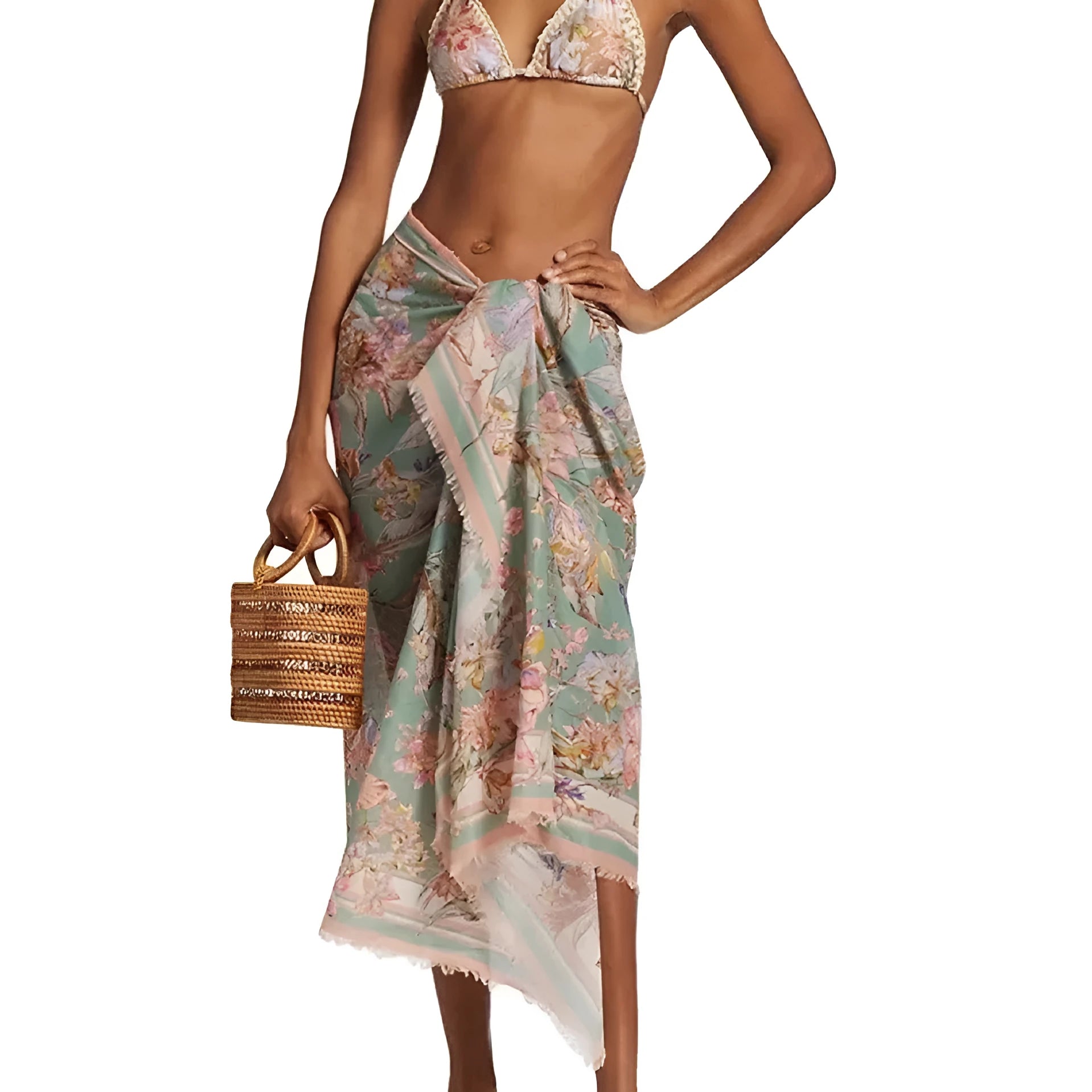 Creamy-white floral print women's three-piece bikini set with top, briefs, and skirt on a beach background.