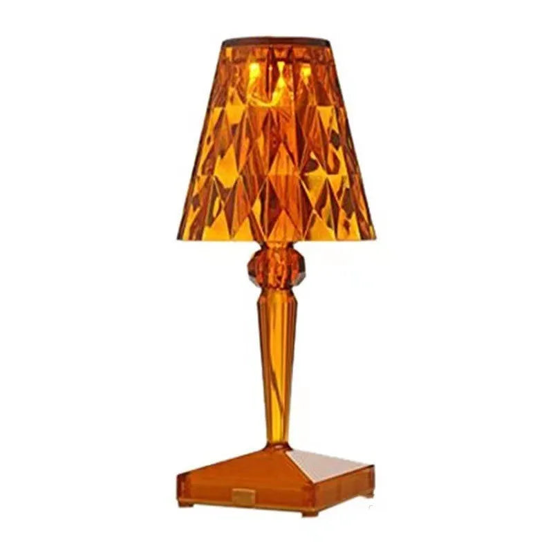 Rose gold plated portable touch control LED night light with acrylic shade on a table.