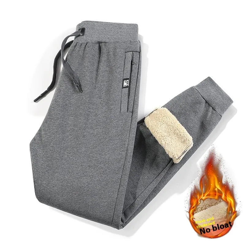 Men's grey fleece-lined oversized cotton track pants with a straight leg, shown on a hanger.