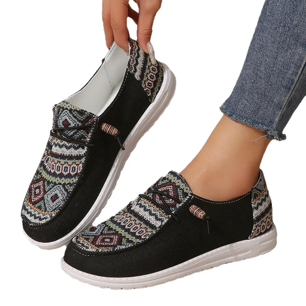 Women's low-top flat shoe in black with round toe and rubber sole, shown as an overshoe cover.