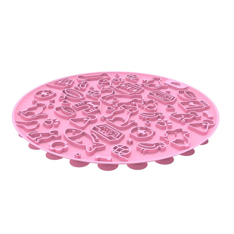 Round silicone pet licking mat with suction cup base in blue, on a kitchen tile floor.