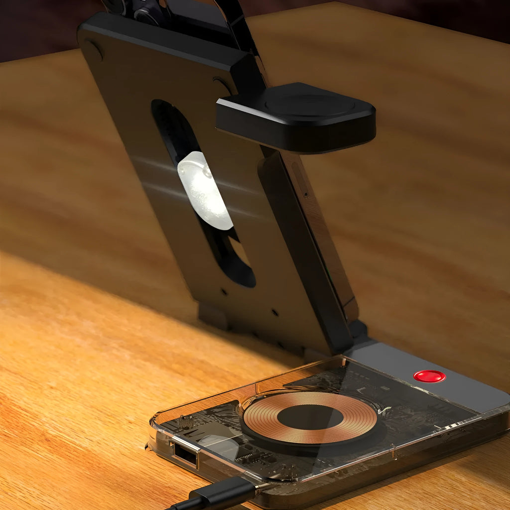 Black foldable magnetic three-in-one wireless charging stand with phone, watch, and earbuds on a desk
