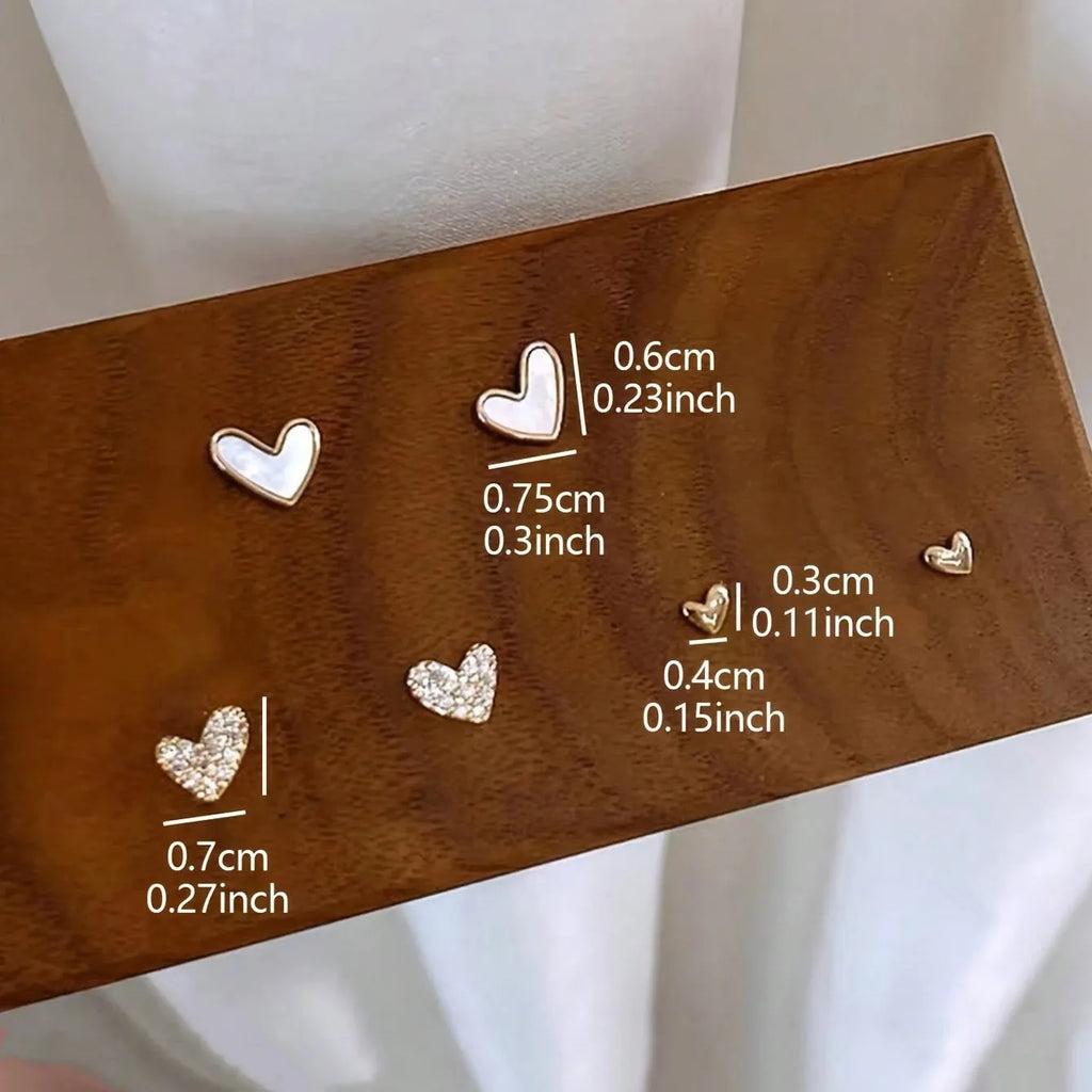 Three pairs of women's heart-shaped alloy earrings in coordinated set with electroplated finish